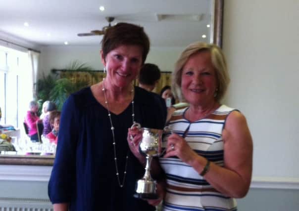 Overall winner Di Law being presented with the trophy by Lady Captain Diana Beningfield