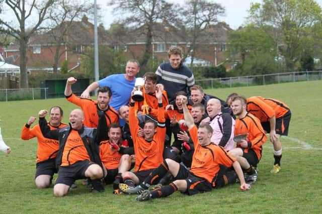 Iden Football Club celebrates winning the Hastings & District FA Intermediate Cup