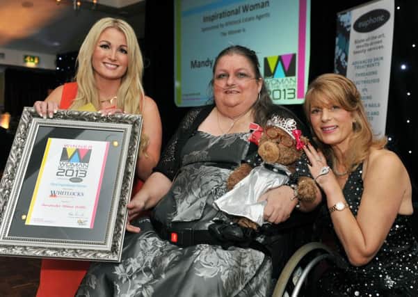 Mandy Paine, centre, being hailed at the Woman of the Year in 2013