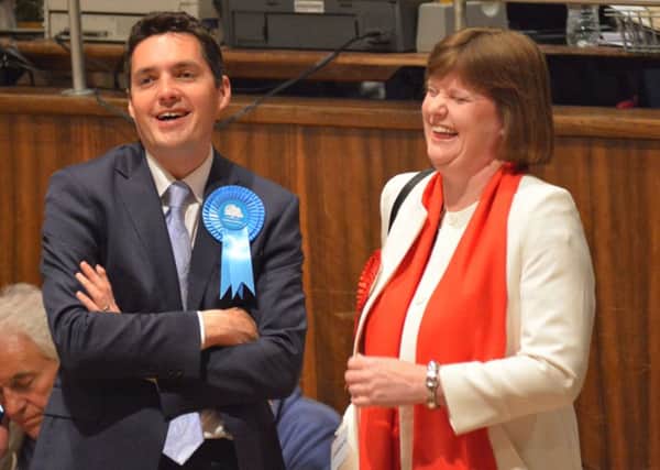 Huw Merriman and Michelle Thew sharing a joke at the Bexhill and Battle election count SUS-150805-025723001