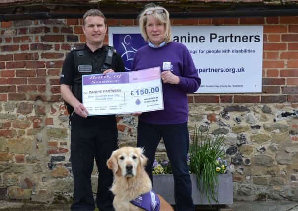 PC Paul Quinnell from Midhurst Police Station and Jane Grant, regional fundraiser at Canine Partners, with demonstration dog Angel