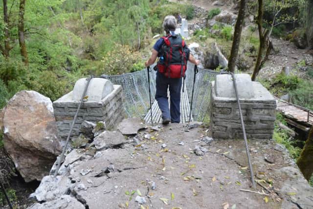 The group had to cross this swing bridge showing cracks at its base