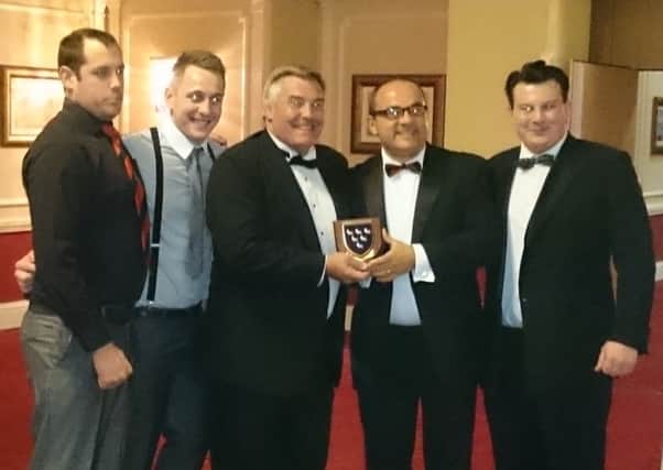 Mark Newey and members of the Heath 1st XV receiving the Sussex Club of the Year shield from Jason Leonard