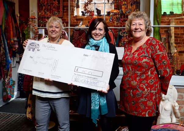Helen Hitchcock and Tracey Eaton of The Gallery at Cobblestone Walk in Steyning donate a cheque for Nepal to Leah Brack SUS-150519-120822001