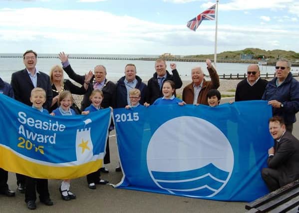 Councillors and pupils from the River Beach Primary School celebrate Littlehampton yet again being awarded the Blue Flag and the Seaside Award for its clean coastline SUS-150520-155636001