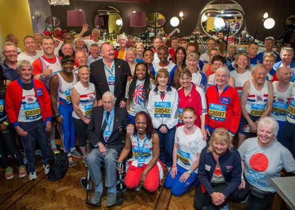 More than 90 Olympians from every Games since 1952 surround 98 year old Olympian Bill Lucas, who competed in the 1948 Games, at a gathering in Henry's Bar ahead of their wave at the Bupa Westminster Mile 2015.

Photo: Neil Turner/Bupa