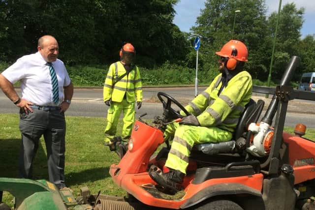 County Council's Cabinet Member for Highways and Transport, John O'Brien, chats to Matt Arnold on his grass cutting round (photo submitted). SUS-150528-130910001