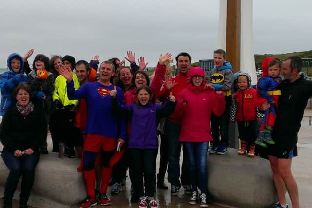 'Superman' Simon Allchin with family and friends at the finish line of his gruelling month-long challenge