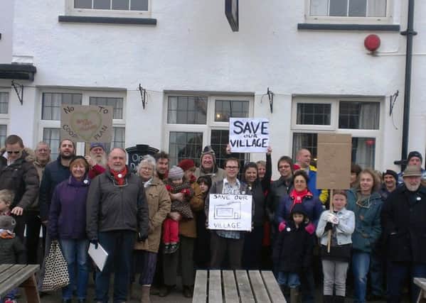 Villagers outside the Royal Oak Pub in East Wittering, protesting against tehe Co-op's plans for a bigger store on the site ENGSUS00120130104143316
