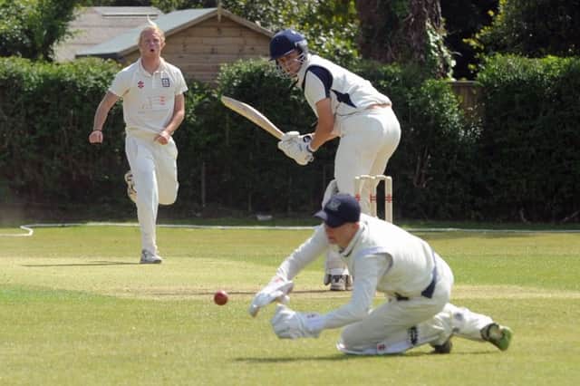 Bexhill bowler Dean Crawford looks on as wicketkeeper Cameron Burgon tries to gather the ball during last weekend's win at Middleton. Picture by Louise Adams (SUS-150531-121044008)