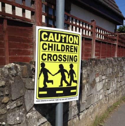 Signs to warn of the nearby infants school in Whyke Road