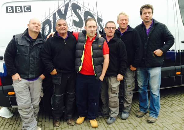 Horsham carpenter Jon Hill-Upperton (centre), with the DIY SOS team. SUS-150506-161622001