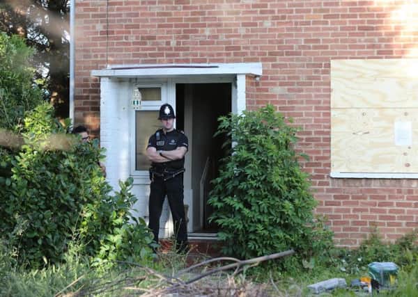 A police officer stands guard at 31, Ash Grove, Bognor Regis on June 5. Picture by Eddie Mitchell