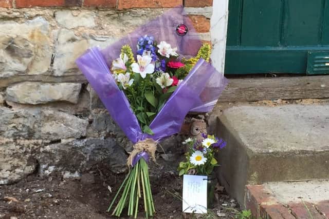 Floral tributes have been paid to Elisabeth Belcher who died during yesterday's blaze SUS-150606-132505001