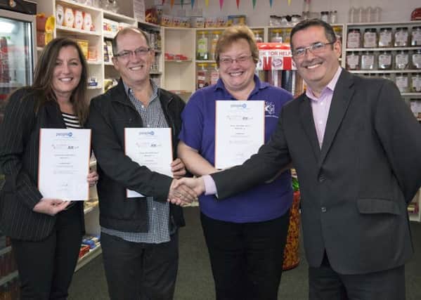 From left: Loraine Perry from Enable Me, Patrick Hill from Hairlucinations and Diane Few from Bah-Humbug Sweets, pose with their course certificates which were handed to them by John Edjvet, Littlehampton Town Centre Regeneration Officer at Arun District Council