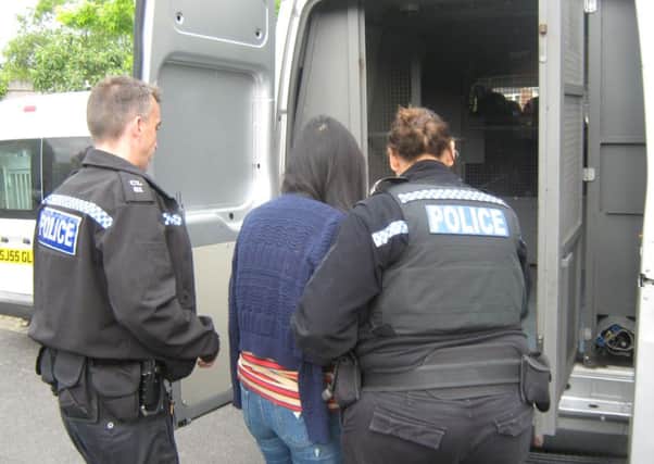 A woman is arrested in Walton as part of the police operation. Photo by Sussex Police