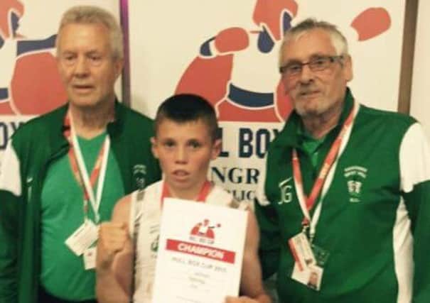 West Hill Boxing Club talent Toby Salmon is flanked by coaches Joe Lee and Johnny Gray