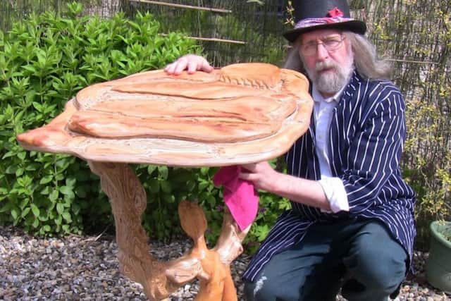 Wild Willy Barrett with one of his carved wood pieces