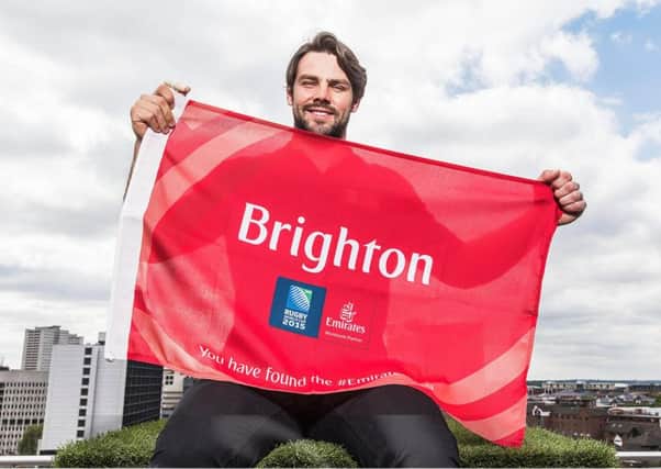England star Ben Foden unveils one of the Emirates flags which will appear in a competition to promote the Rugby World Cup in Brighton. SUS-151106-181153002