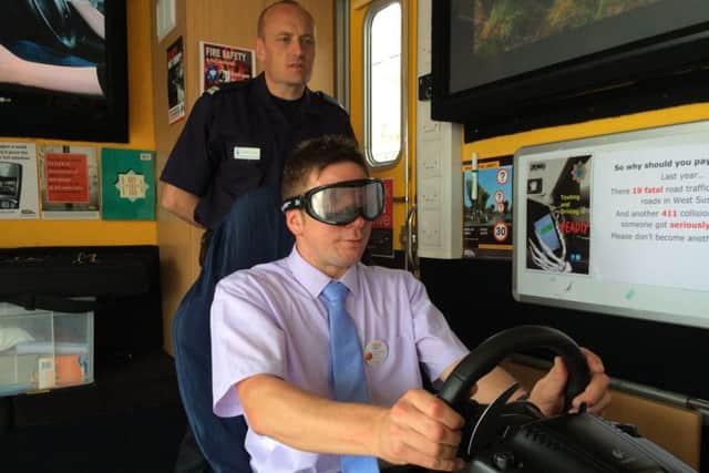 Bognor Tesco duty manager Russell MacMorland trying the drink drive simulator, watched by Simon Foster from West Sussex Fire & Rescue Service SUS-150615-144755001