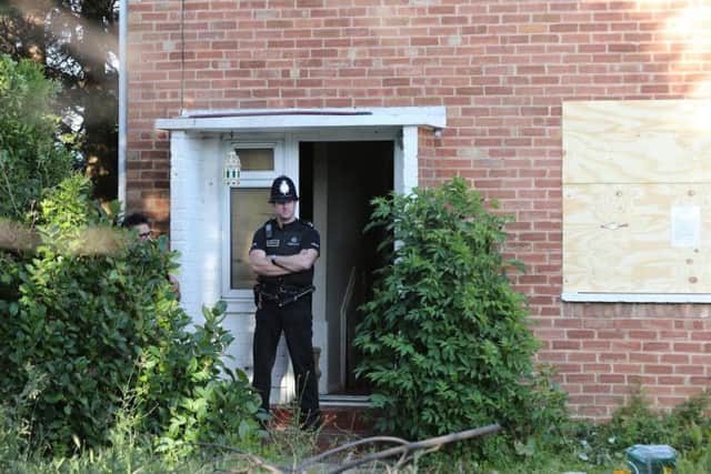 A police officer stands guard at 31, Ash Grove, Bognor Regis, on June 5. Picture by Eddie Mitchell