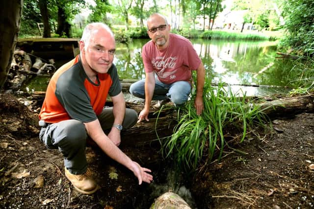 Two lakes in Ayshe Court Drive could run dry after a leak was discovered. They have no council support and are pushing for funds for sandbags. Richard Bryant and Nigel Cawston and the site of the leak. Pic Steve Robards SR1514442 SUS-150623-141603001