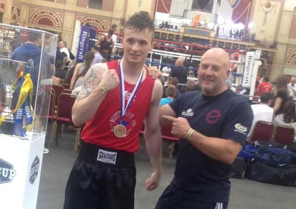 Danny Kirkland shows off his Haringey Boxing Club gold medal with trainer Rob Purkis