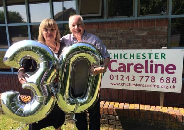 Brenda Jackson and Vince Foot, Chichester Careline manager present and past celebrating the 30th birthday SUS-150630-130121001