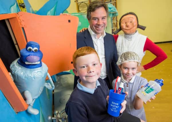 06/07/2015 - Ciaran McCrickard Photography - Southern Water Drips Show travels to Warnham Primary School, Horsham, West Sussex, to teach the children about water saving in the home. Pictured are pupils Charlie and Lottie Sas with Daisy Drip, and local MP Jeremy Quin SUS-150807-103617001