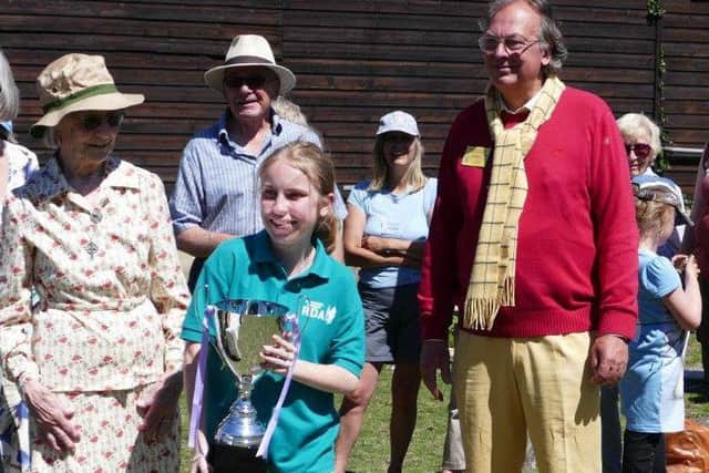 Michelle, Class 3 winner and rider with highest percentage score, receiving the Hilary and Sheila Tangye Trust Trophy from Lady Emmett, with Terry Clothier