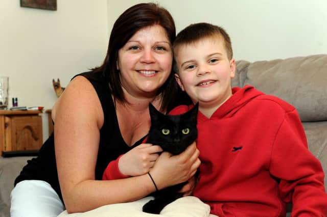 Bert the cat is back home after being missing for 6 years. Kim Harris and her son Josh. Pic Steve Robards SR1518240