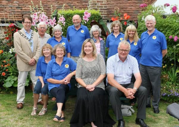 Judges Chris Evans and Linda Ball, front, with the Angmering in Bloom team and Arun District Council chairman Andy Cooper at The Spotted Cow DM1515982a