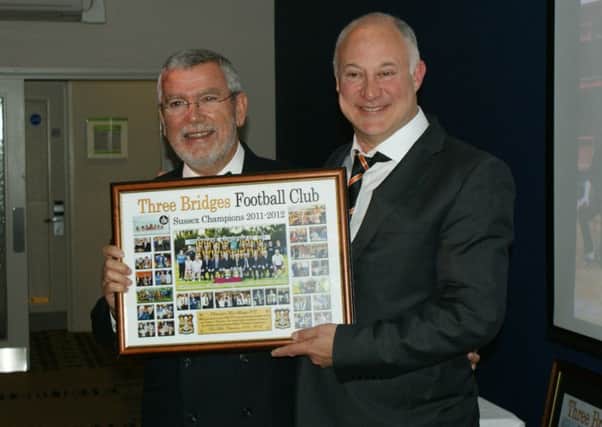 President Alan Bell presents a special board of newspaper cuttings featuring the club's coverage to first team manager Paul Faili SUS-140605-141220002