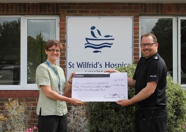 Chief inspector Justin Burtenshaw presents the cheque to St Wilfrid's Hospice