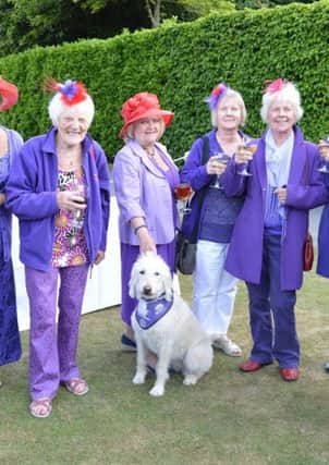Guests from The Red Hat Society with demonstration dog Saffy