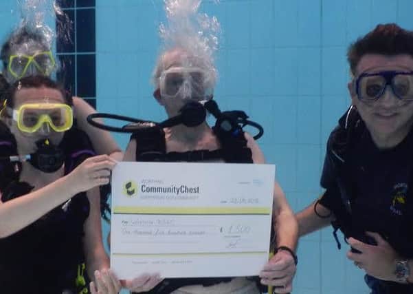 Worthing Community Chest present Worthing BSAC diving club with the cheque
