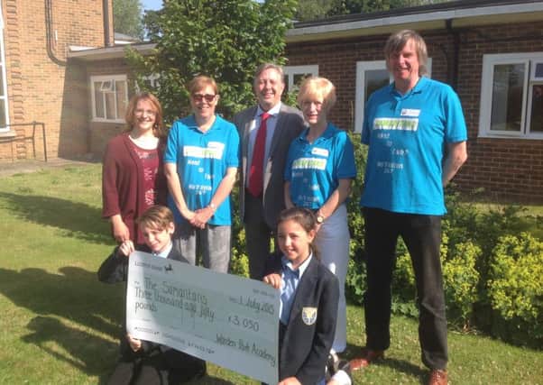 Warden Park pupils present cheques to their chosen charities SUS-150724-101128001