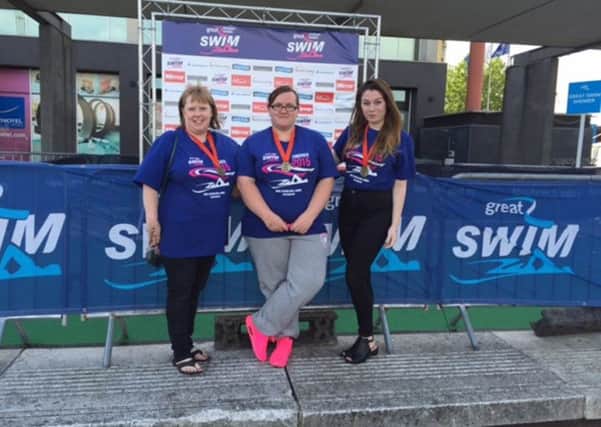 Julie, Louise and Hannah proudly wearing their medals. SUS-150728-143522001