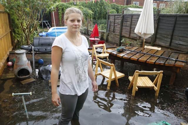 Emma Lyons in her flooded garden in July, 2014. Picture by Eddie Mitchell