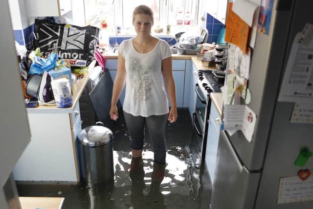 Emma Lyons in her flooded kitchen in 2014. Picture by Eddie Mitchell