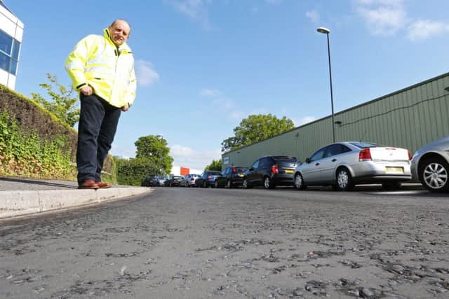 John O'Brien Inspecting the new and improved road surface at Wheatstone Close, Crawley (photo submitted). SUS-150728-111457001