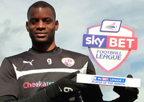 Crawley Town's Skybet Player of the Month winner Izale McLeod with his award SUS-150903-193751002