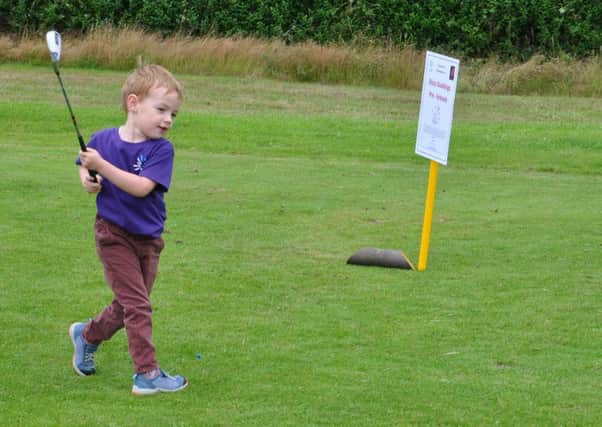 Leo, Jodie's eldest son, taking the first tee to start the event