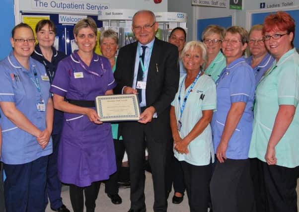 Outpatients staff at Eastbourne DGH with chairman Stuart Welling SUS-150731-114027001