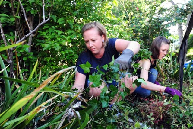 Karen Grimes and Kelly Rudin at work in the garden, as part of a scheme to provide help in the community ks1500313-1