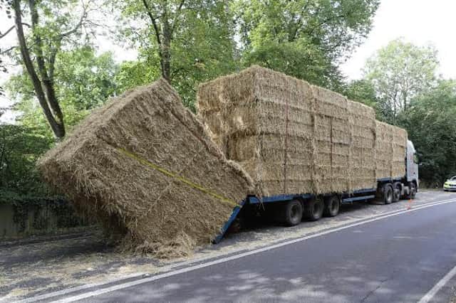A281 blocked after 50 hay bales fell off truck