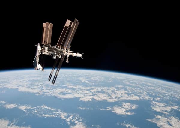 International Space Station and the docked space shuttle Endeavour, left, at an altitude of approximately 220 miles. (AP Photo/NASA, Paolo Nespoli)