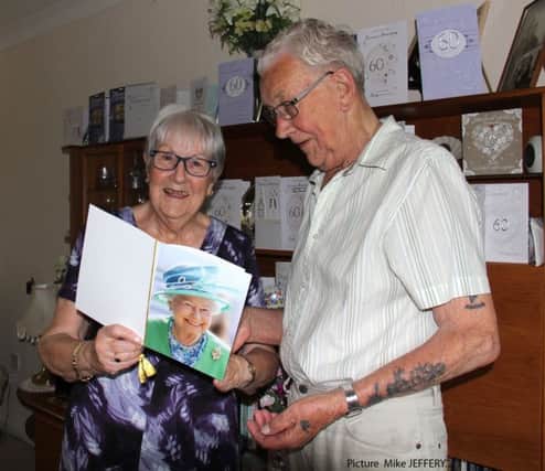 Geof and Joan Laker, with the card they received from the Queen PICTURE: MIKE JEFFERY