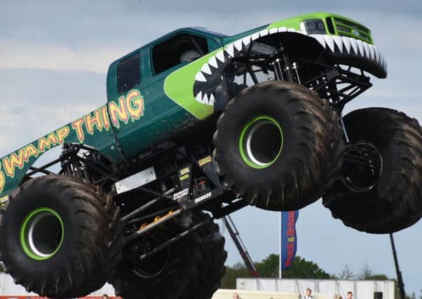Truckfest 2015 at the East of England Showground. Monsters Trucks Swamp Thing v Slingshot EMN-150305-191833009