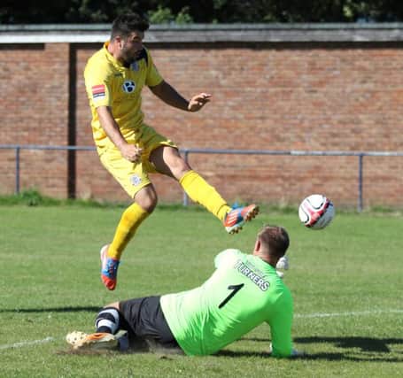 Sam Cole tries to lift the ball over the goalkeeper for Hastings United in last weekend's pre-season friendly against Ringmer. Picture courtesy Scott White